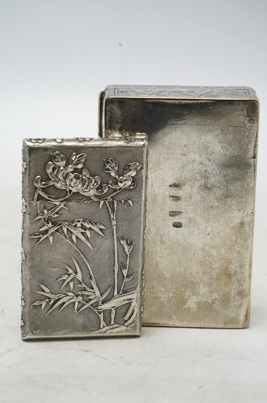 An early 20th century Chinese Export white metal card case by Wang Hing, 84mm, together with a Chinese white metal box with hinged cover. Condition - fair to good